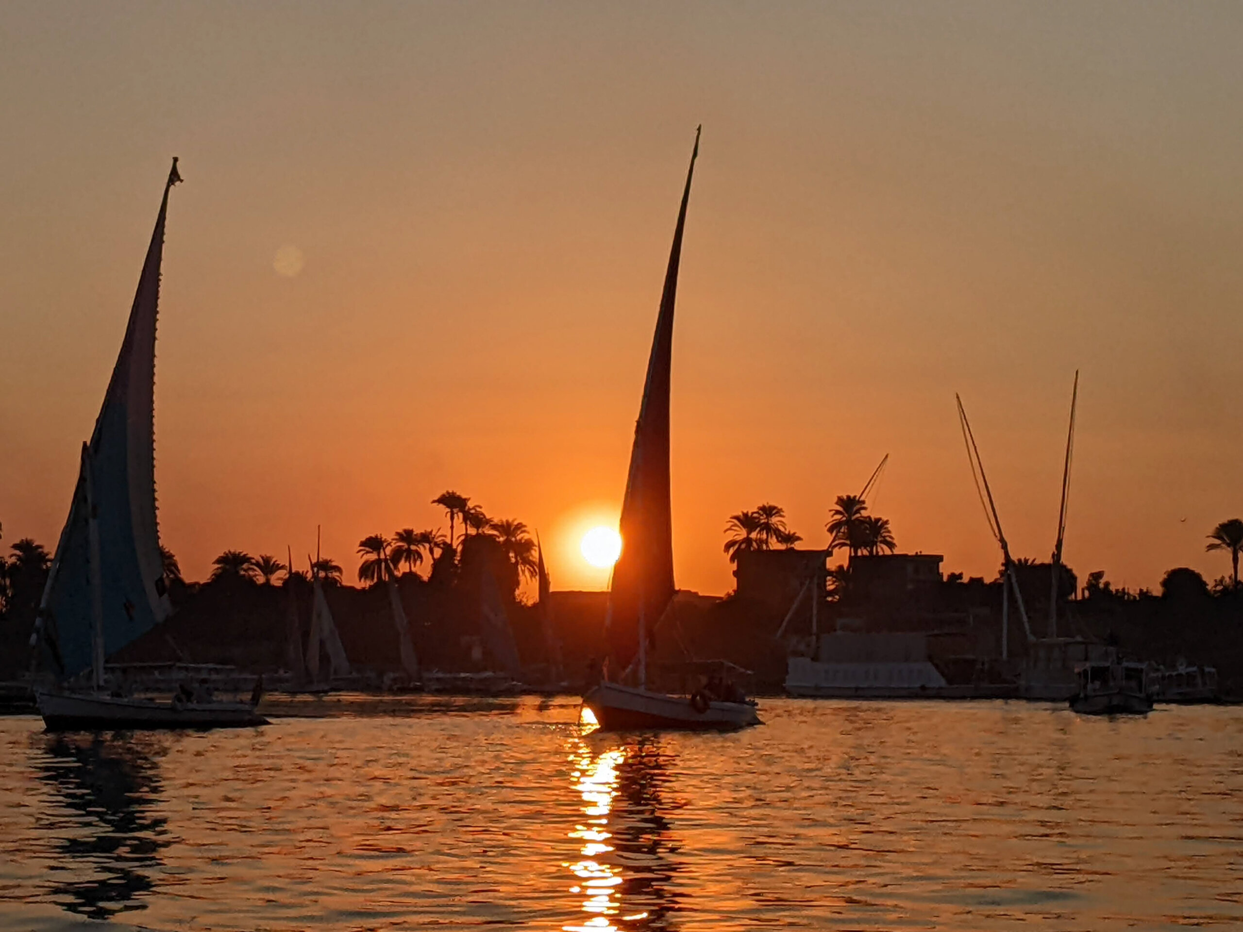 sunset-feluccas-nile-river-luxor-egypt